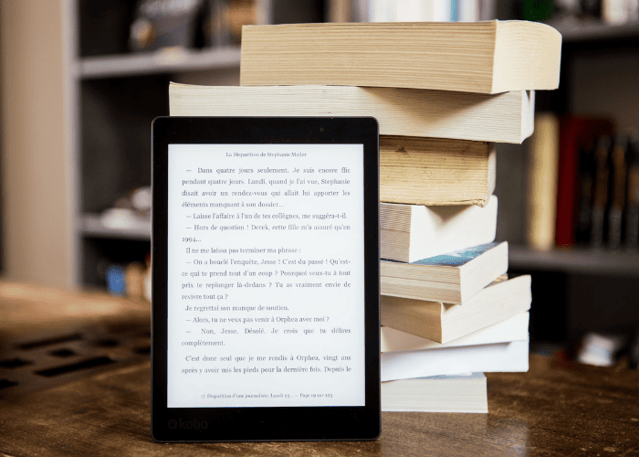 eBook Publishing on a digital reader beside printed books, showcasing the future of modern book publishing
