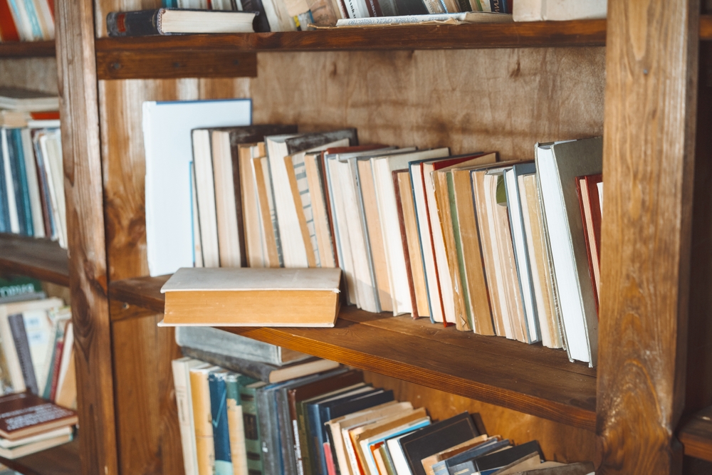 A,Wooden,Bookshelf,With,Many,Books,On,It.,A,Book